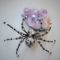Beaded wire spider featuring a detailed silver-patterned bead, black legs, and shimmering accent beads for a mystical handmade décor piece.